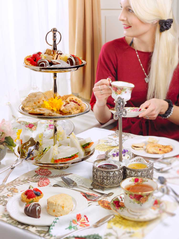 A woman enjoying a tea at a table